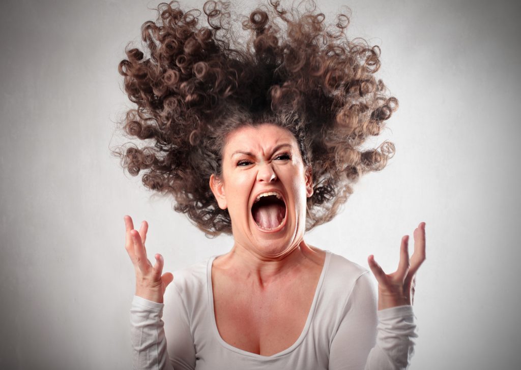 woman with curly hair screaming